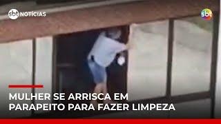 Tudo por vidro brilhando? Mulher se arrisca em parapeito para limpar janela | #SBTNotícias