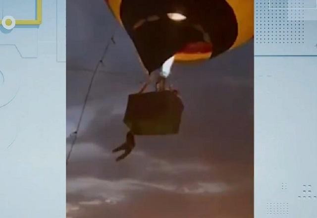 Rapaz fica pendurado e cai de balão após forte rajada de vento